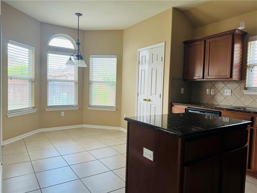 7541 Exeter Corpus Christi, TX 78414 - Photo 4 of 13 a kitchen with granite countertop a sink cabinets and window