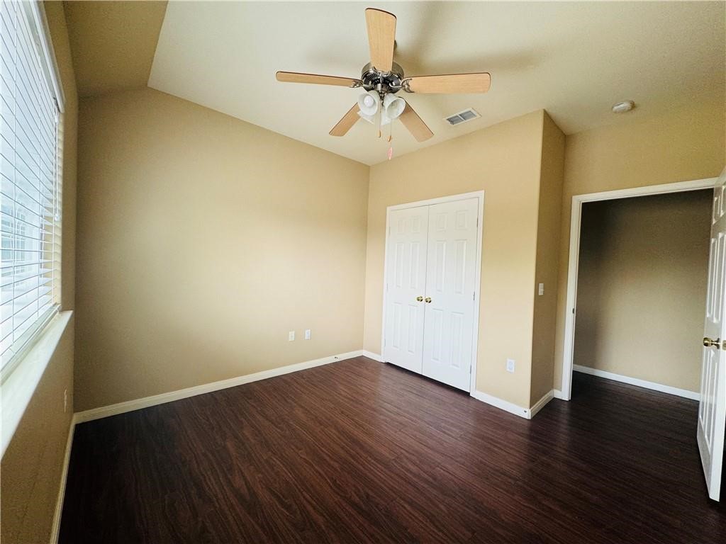 7541 Exeter Corpus Christi, TX 78414 - Photo 8 of 13 an empty room with wooden floor closet and windows