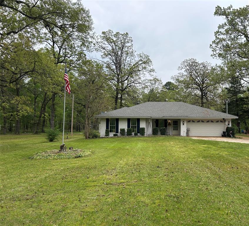 5236 Linton Cutoff Road Benton, LA 71006 - Photo 1 of 1 Ranch-style house featuring driveway, an attached garage, and a front lawn
