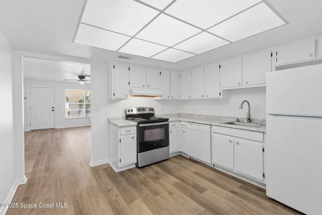 a bathroom with a sink a toilet and shower curtain