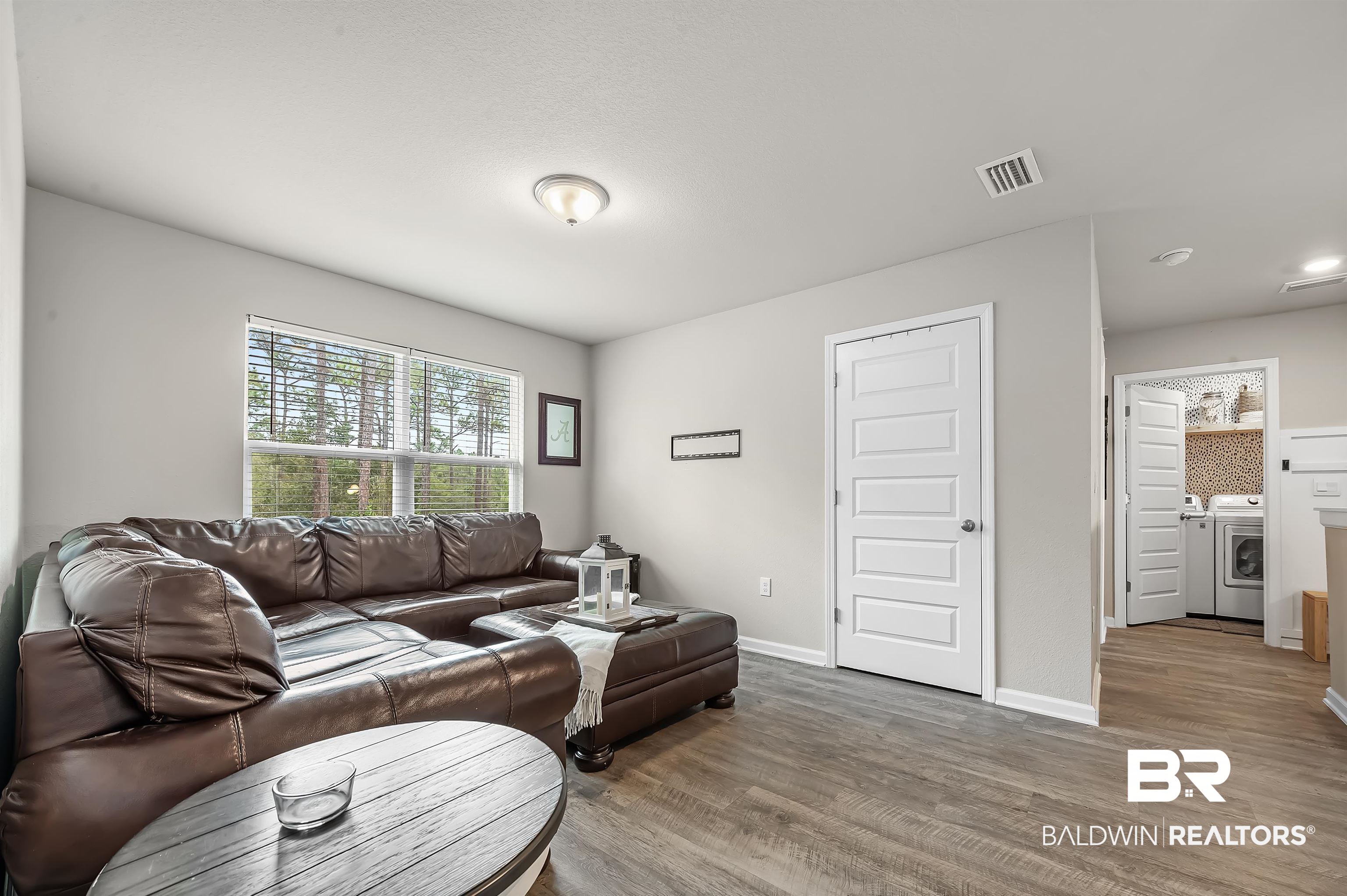 24549 Broken Sound Loop Orange Beach, AL 36561 - Photo 26 of 57 Living room with washer and clothes dryer and hardwood / wood-style floors