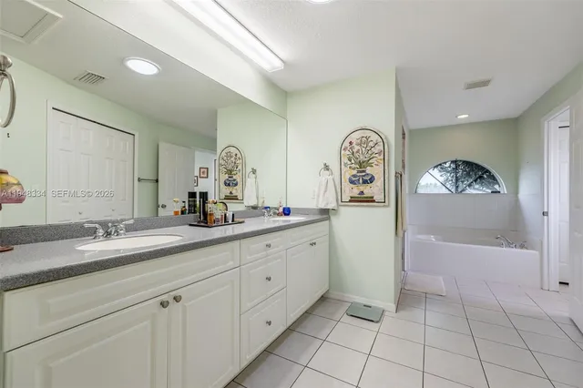 a white bath tub sitting next to a small bathroom