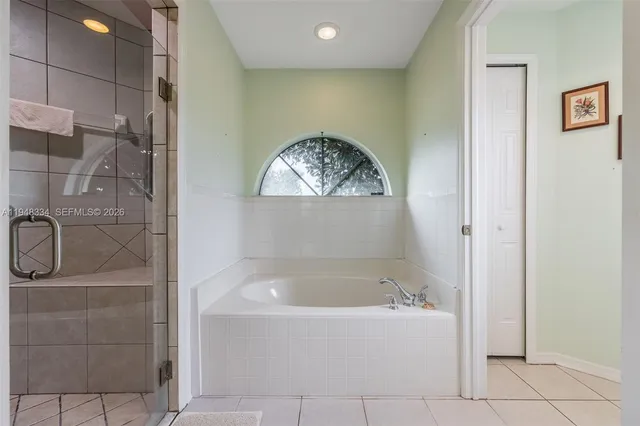 a view of walk in closet with clothes