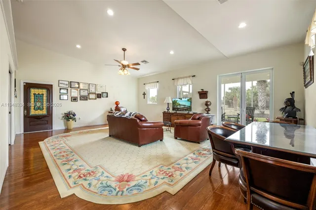 a living room with furniture and kitchen view