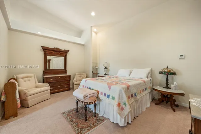a bathroom with a sink a mirror a vanity and a shower