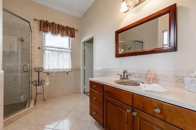 a living room with patio furniture and a floor to ceiling window