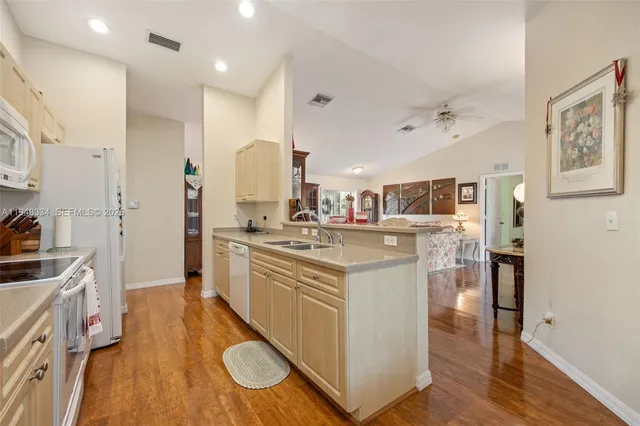 a dining room with furniture a chandelier and wooden floor