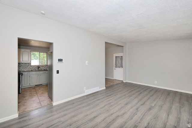 1272 Cook Street Ogden, UT 84404 - Photo 8 of 46 Spacious interior featuring wood-finish flooring and light gray walls