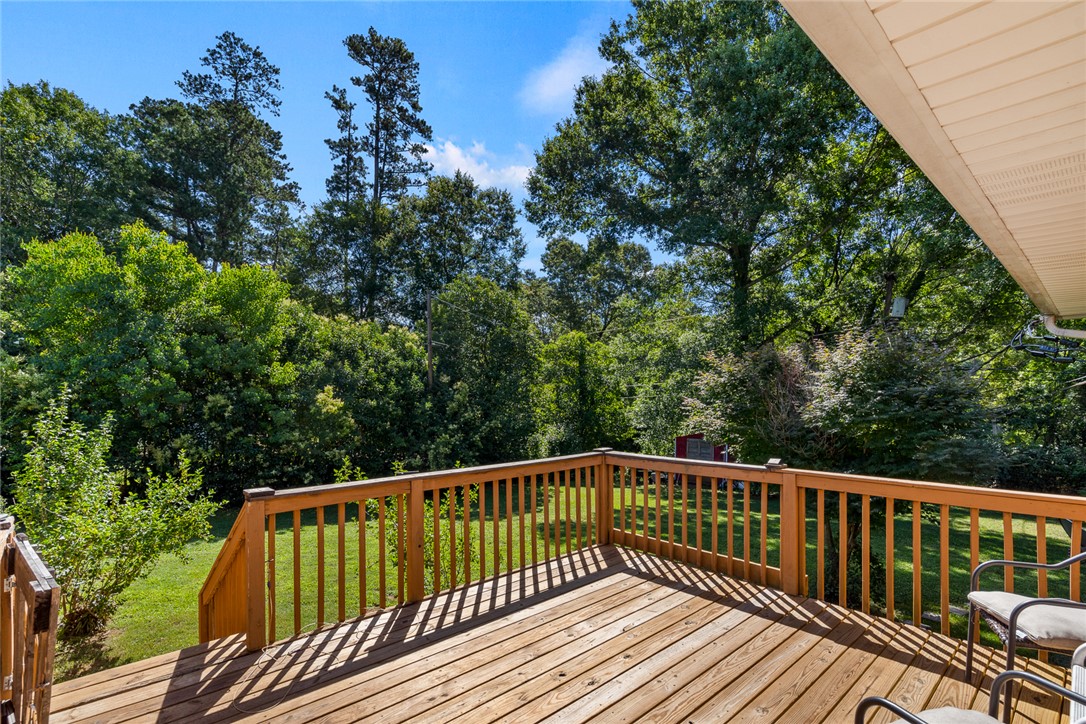 512 East Fredericks Street Anderson, SC 29621 - Photo 25 of 31 A spacious wooden deck provides an elevated vantage point overlooking a verdant, secluded yard.