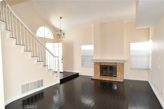a living room with wooden floors and a fireplace