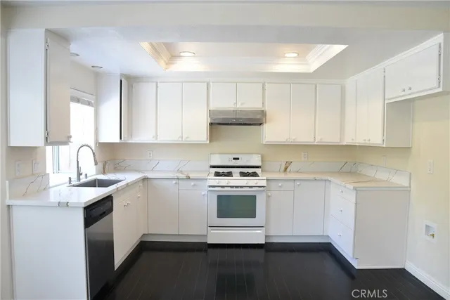 a kitchen with a sink stove and cabinets