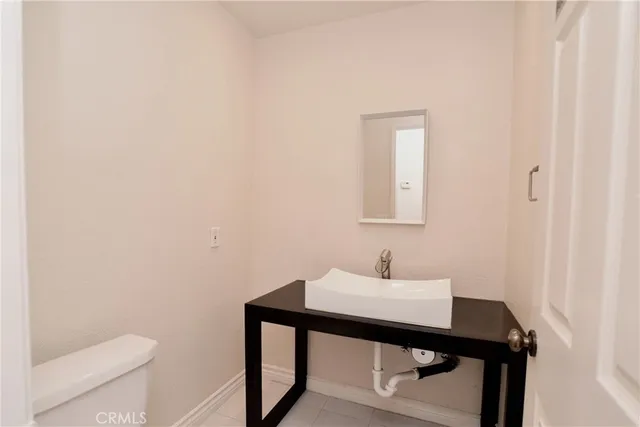 a bathroom with a sink a toilet and mirror