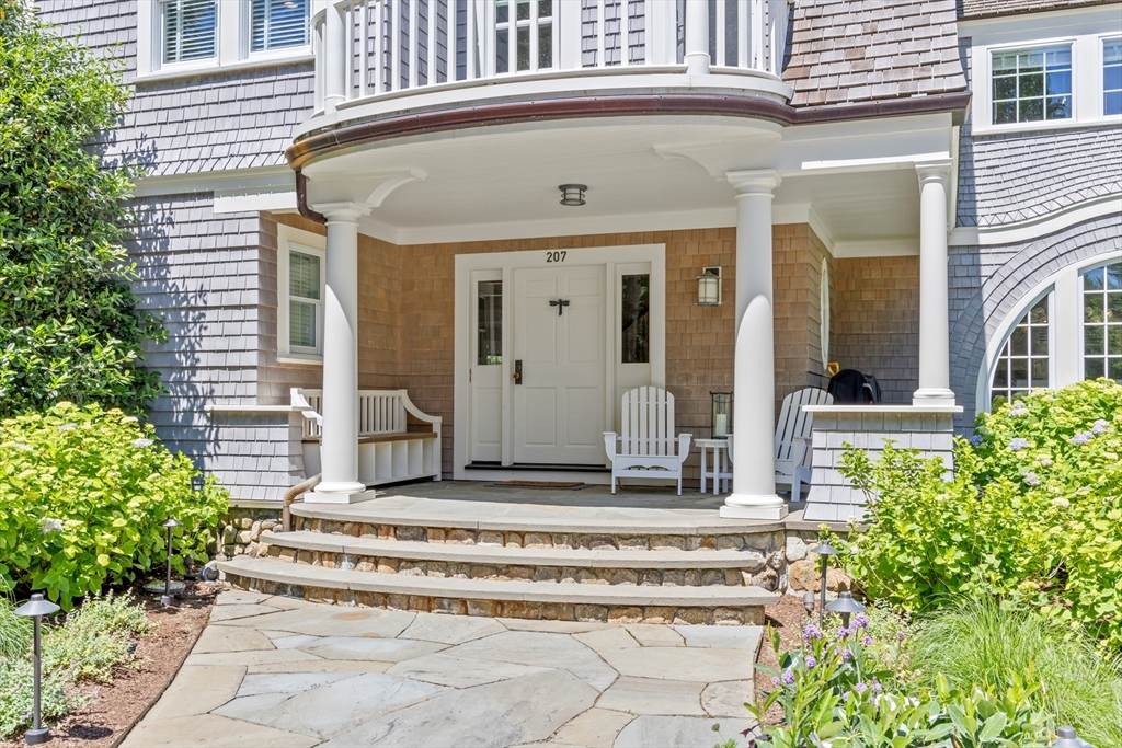 207 Pineleigh Path Barnstable, MA 02655 - Photo 11 of 42 a view of a house with potted plants and a table and chair