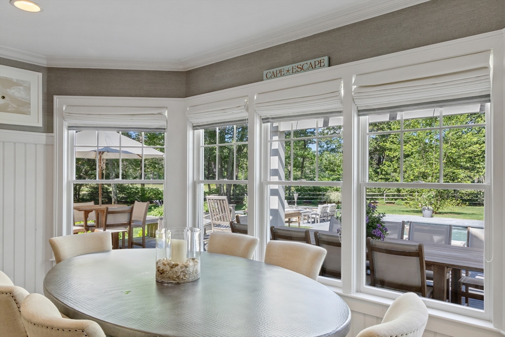 207 Pineleigh Path Barnstable, MA 02655 - Photo 15 of 42 a dining room with furniture and large windows