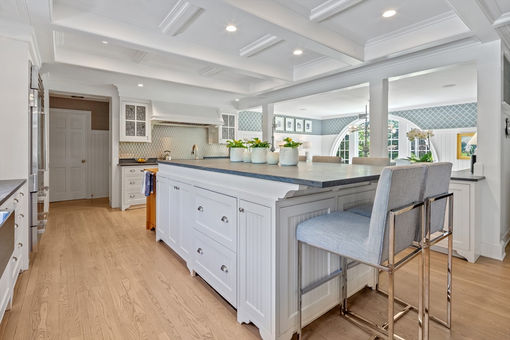207 Pineleigh Path Barnstable, MA 02655 - Photo 22 of 42 a kitchen with stainless steel appliances kitchen island granite countertop a stove a sink and white cabinets