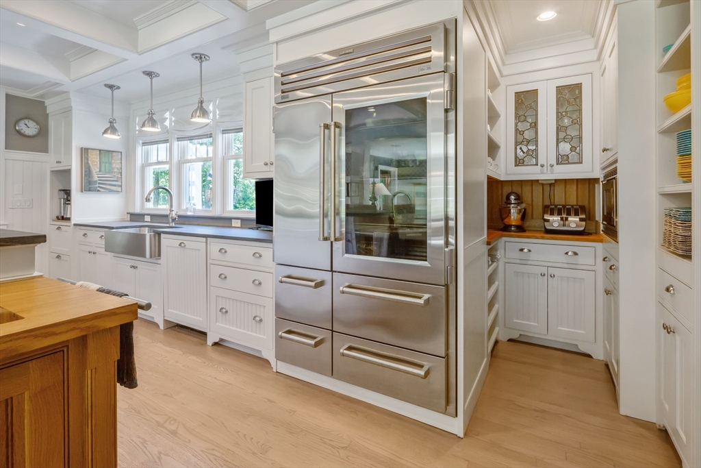 207 Pineleigh Path Barnstable, MA 02655 - Photo 24 of 42 a kitchen with white cabinets and white appliances