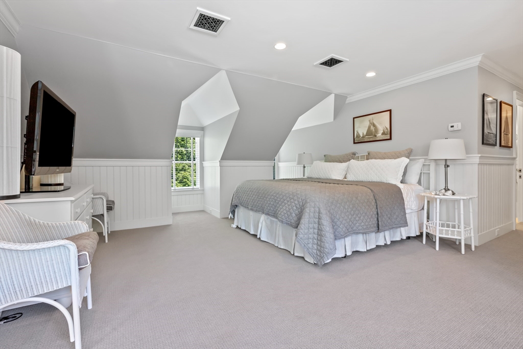 207 Pineleigh Path Barnstable, MA 02655 - Photo 35 of 42 a bedroom with a bed and a flat screen tv