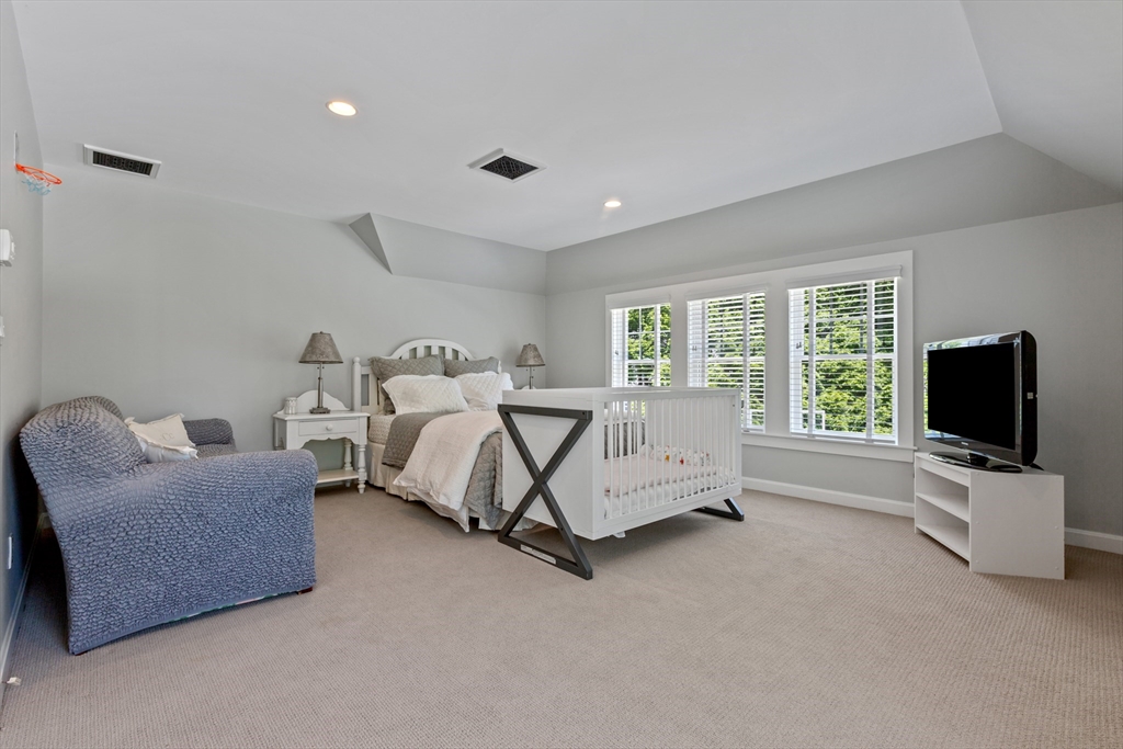 207 Pineleigh Path Barnstable, MA 02655 - Photo 37 of 42 a bed room with furniture and a flat screen tv