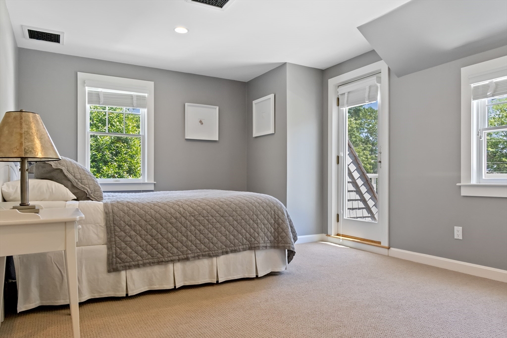 207 Pineleigh Path Barnstable, MA 02655 - Photo 38 of 42 a bedroom with a bed lamp and a large window