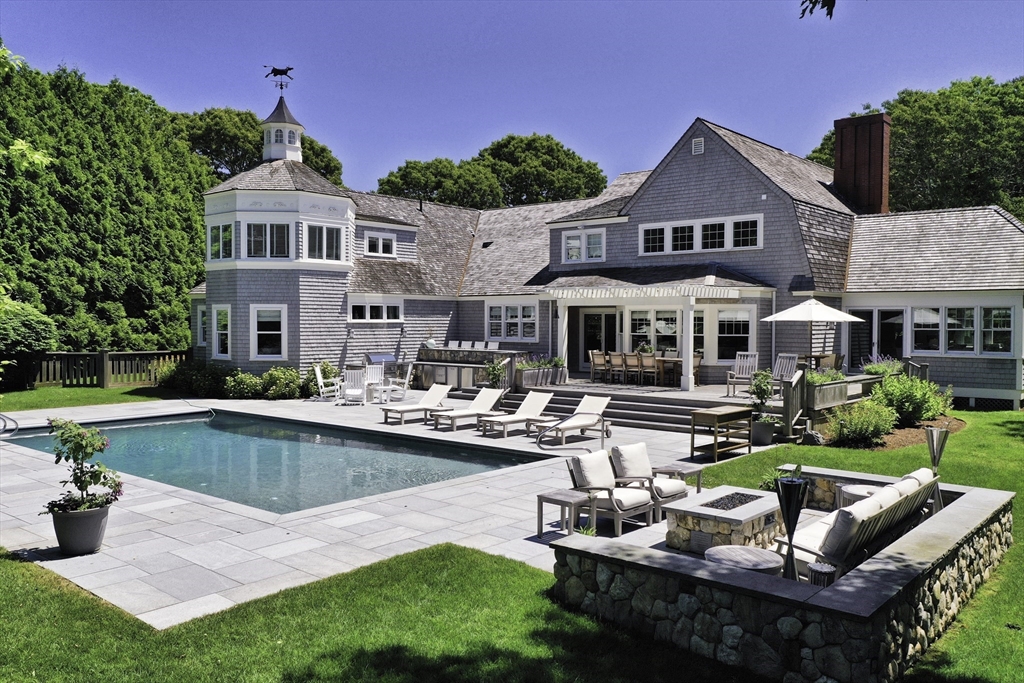 207 Pineleigh Path Barnstable, MA 02655 - Photo 6 of 42 a front view of a house with garden and sitting area