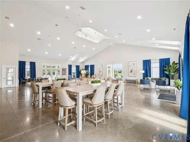 a living room with furniture and a view of kitchen