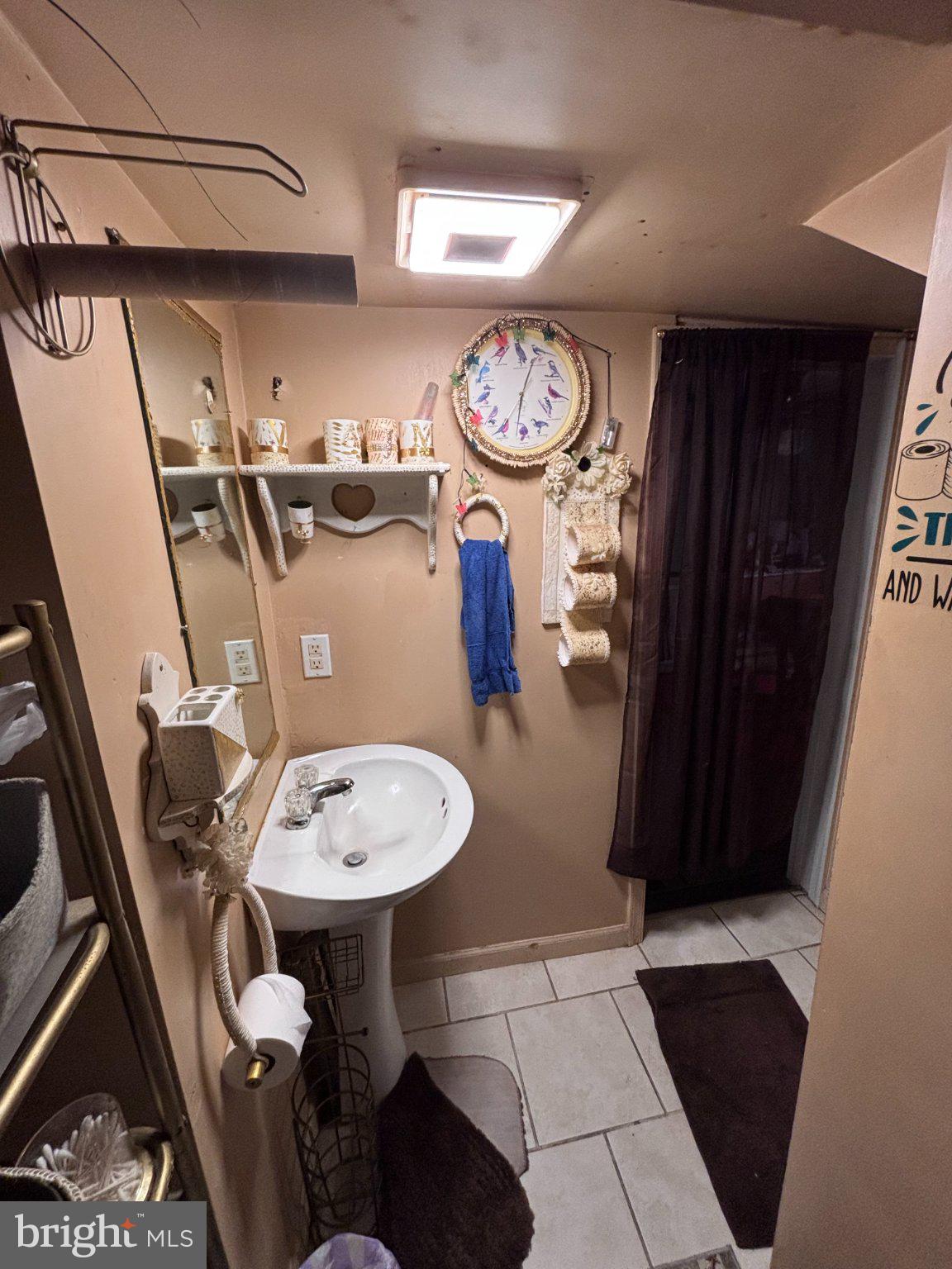 810 Locust Street Cambridge, MD 21613 - Photo 15 of 19 Charming bathroom with cozy decor.