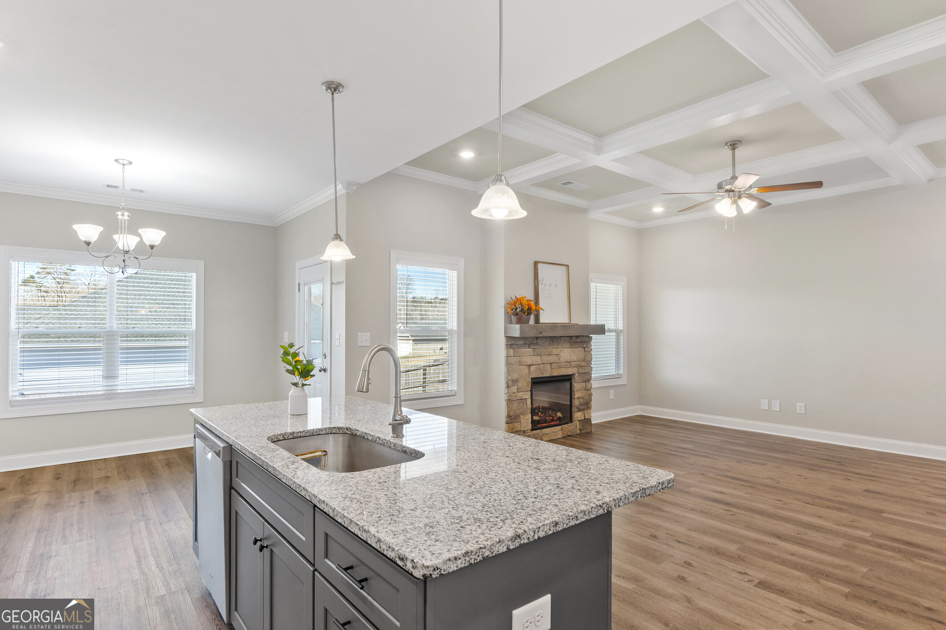 1101 Adirondac Way Bonaire, GA 31005 - Photo 12 of 31 an open kitchen with granite countertop a stove and a wooden floor