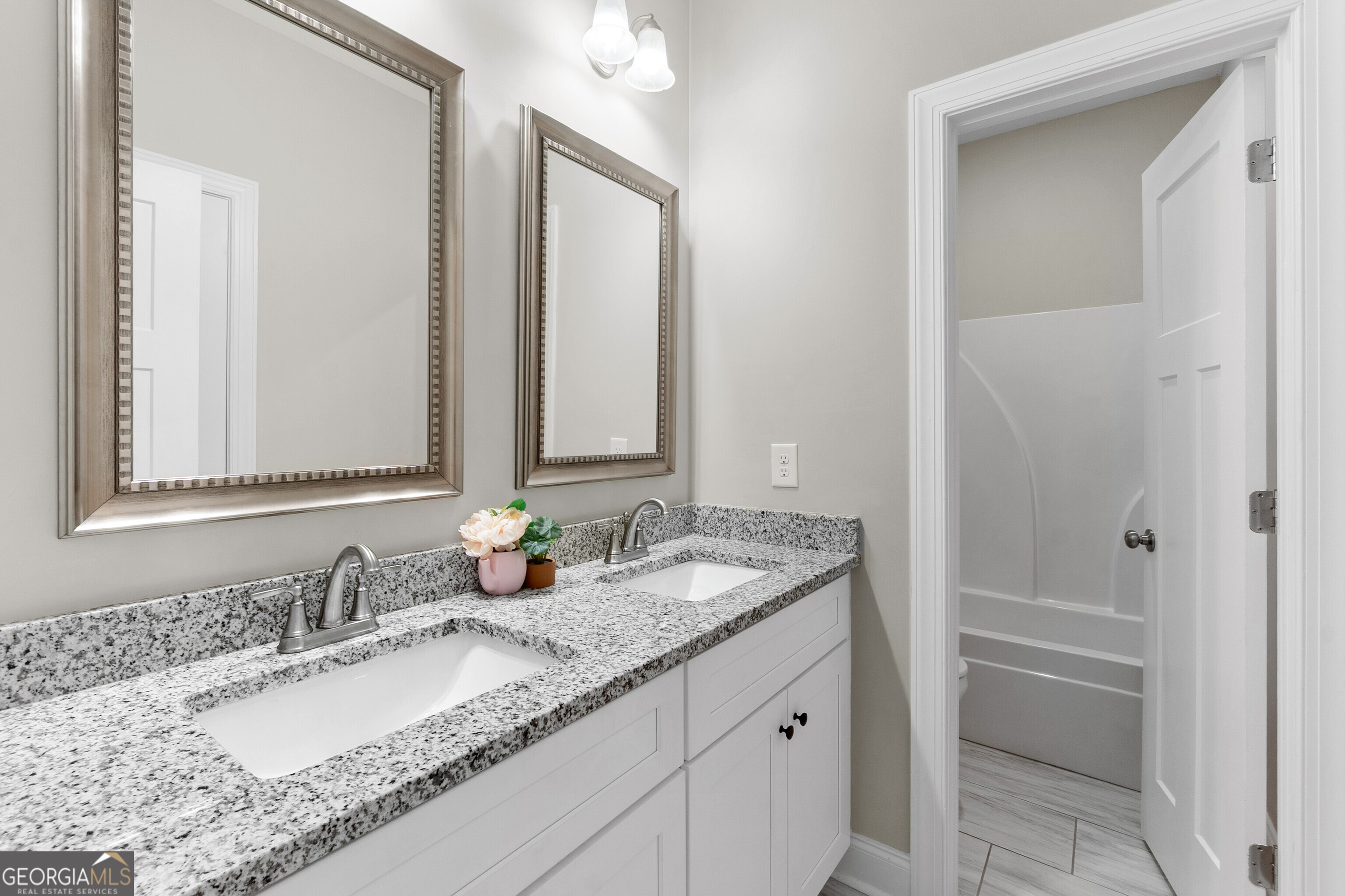 1101 Adirondac Way Bonaire, GA 31005 - Photo 23 of 31 a bathroom with a granite countertop sink and a mirror