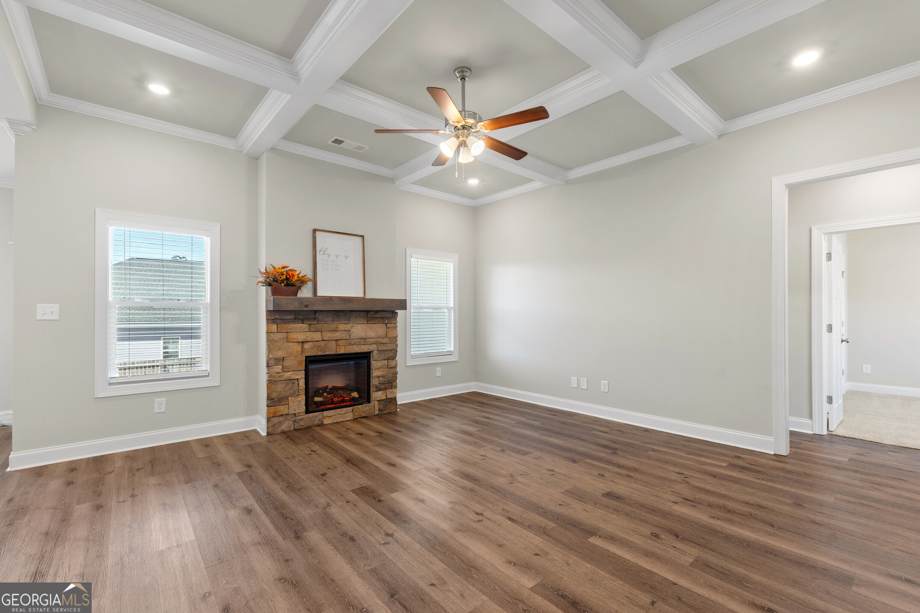 1101 Adirondac Way Bonaire, GA 31005 - Photo 6 of 31 an empty room with windows fireplace and wooden floor