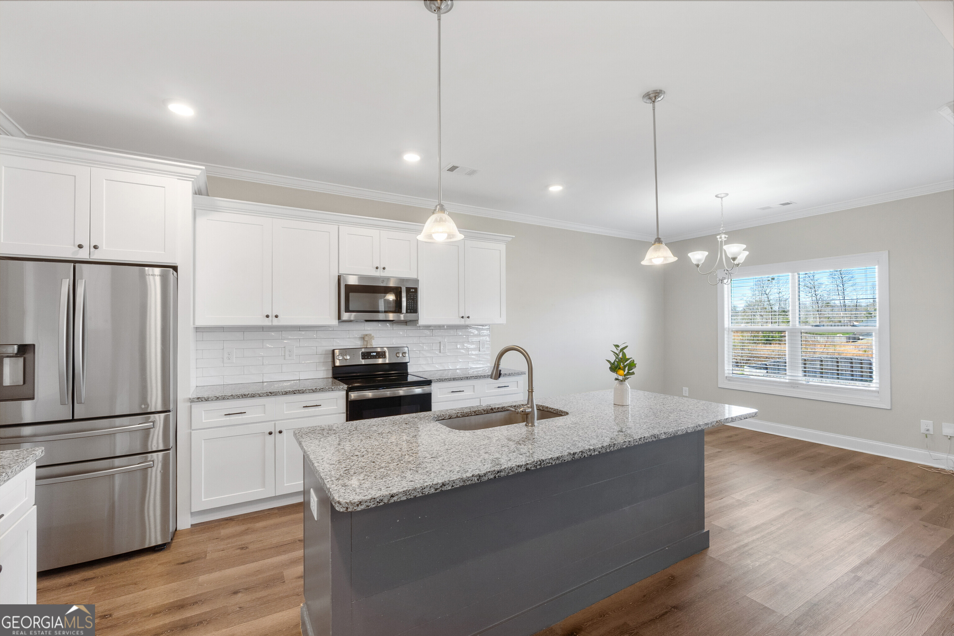 1101 Adirondac Way Bonaire, GA 31005 - Photo 10 of 31 a kitchen with stainless steel appliances granite countertop a refrigerator a sink dishwasher a stove and white countertops with wooden floor