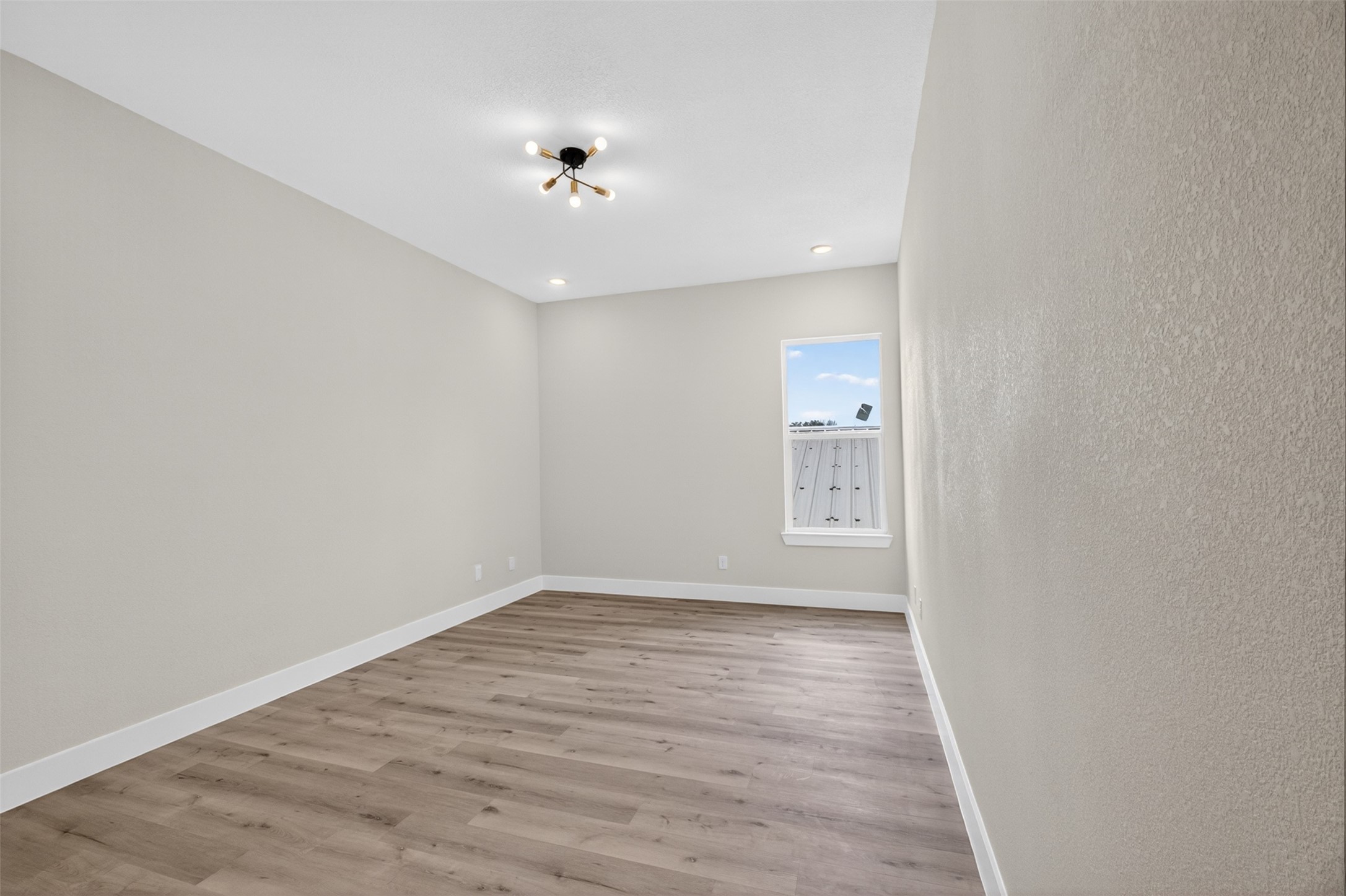5906 St Augustine Street, Unit F Houston, TX 77021 - Photo 23 of 34 Additional bedroom with wood-look flooring, recessed lighting, and neutral finishes.