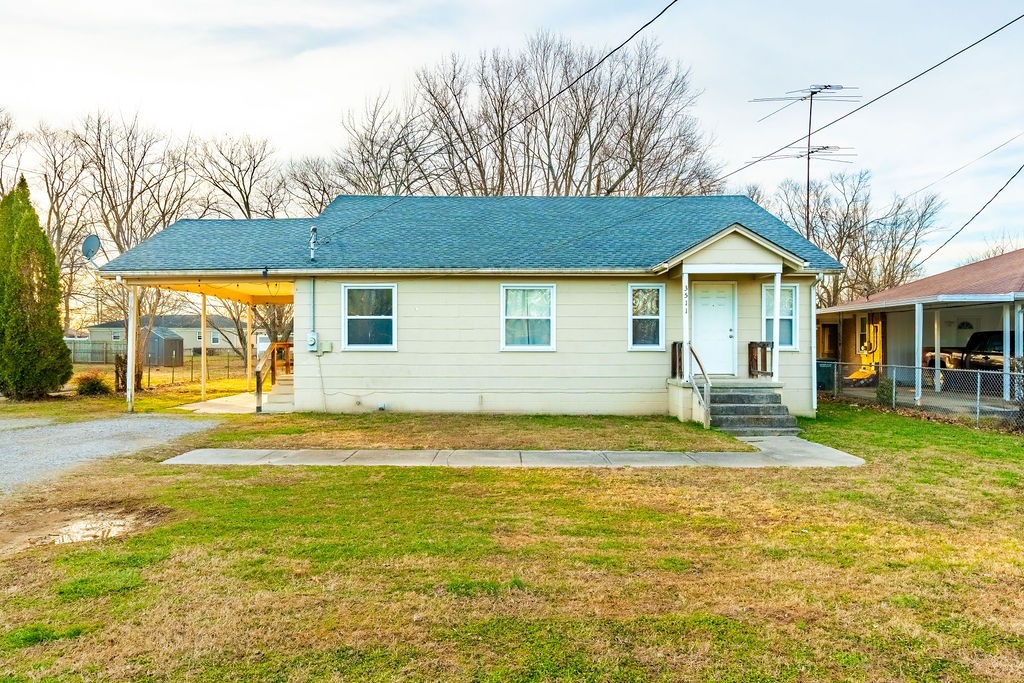a view of a house with a yard patio and fire pit