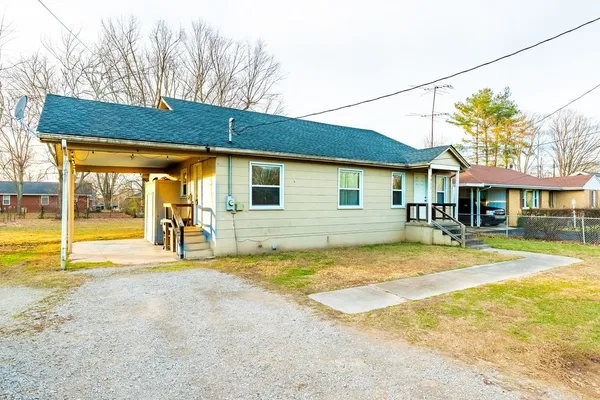a view of a house with swimming pool and a yard