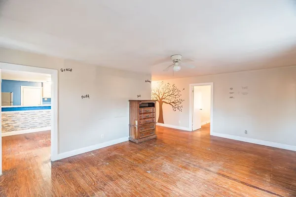 wooden floor in an empty room with a window