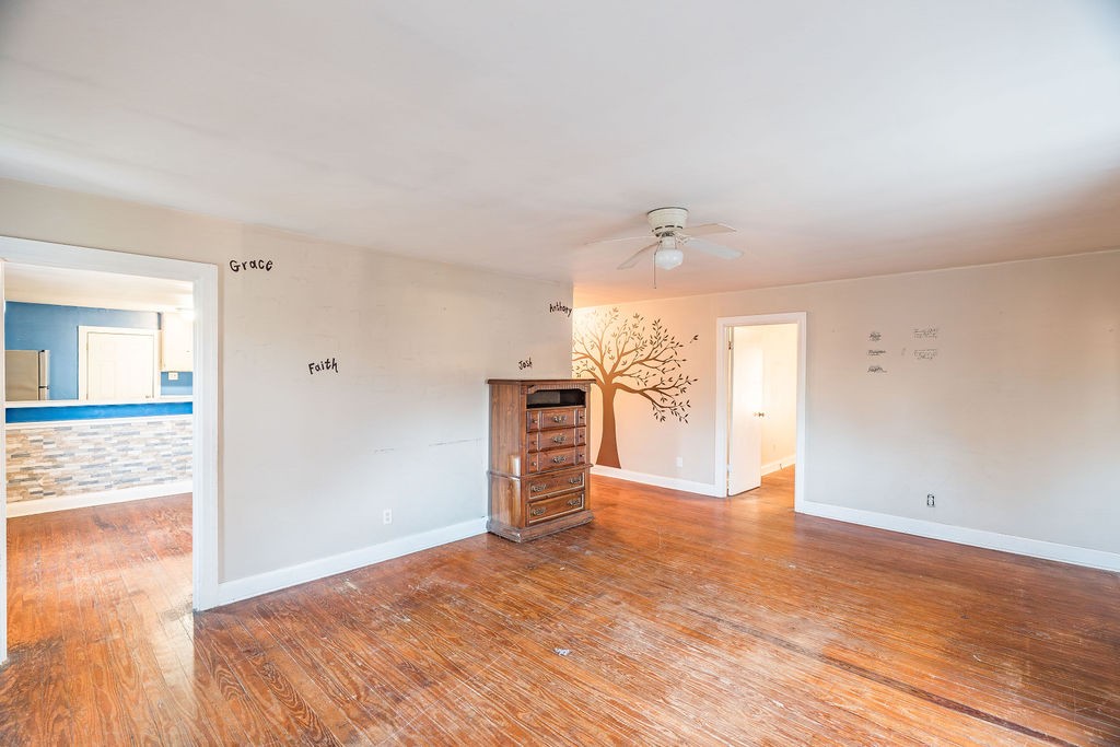 3511 Lafayette Road Hopkinsville, KY 42240 - Photo 2 of 19 wooden floor in an empty room with a window