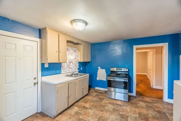 a kitchen that has a sink and a stove