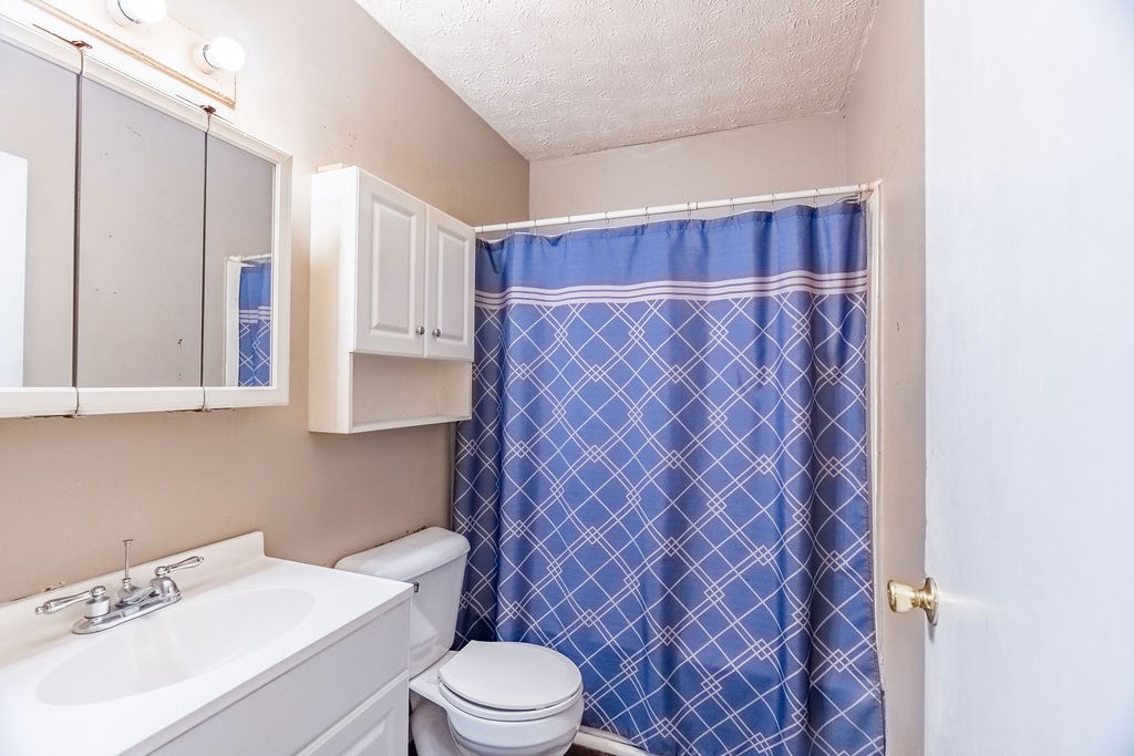 3511 Lafayette Road Hopkinsville, KY 42240 - Photo 8 of 19 a bathroom with a sink a toilet and shower curtain