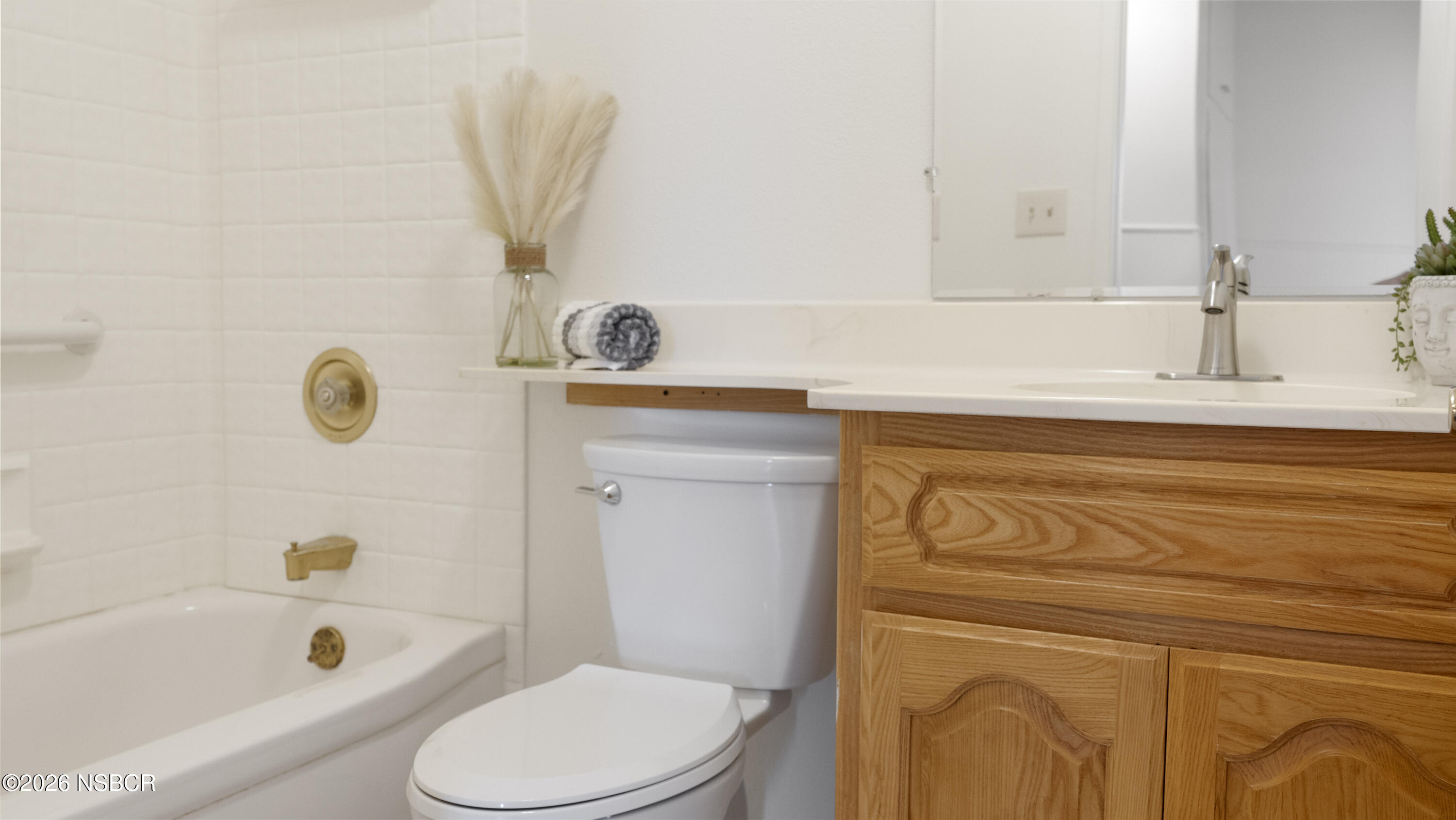 1312 North First Place Lompoc, CA 93436 - Photo 23 of 38 a bathroom with a sink a toilet and bathtub