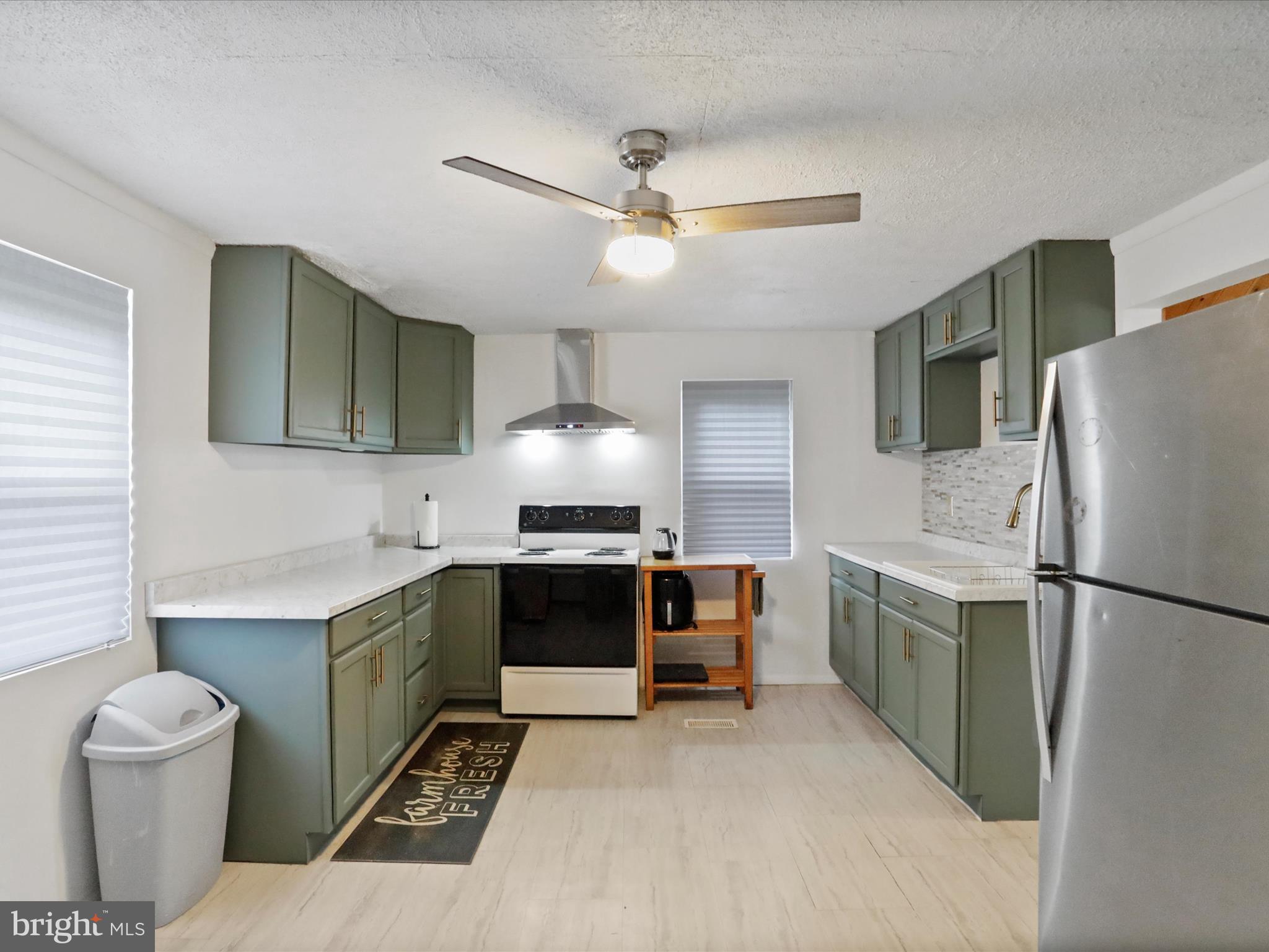16112 Calla Hill Road Northwest Mount Savage, MD 21545 - Photo 11 of 27 a kitchen with stainless steel appliances a stove a refrigerator and a sink