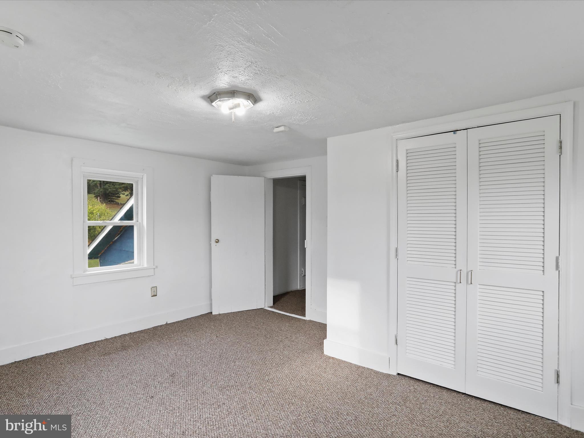 16112 Calla Hill Road Northwest Mount Savage, MD 21545 - Photo 17 of 27 an empty room with windows and closet