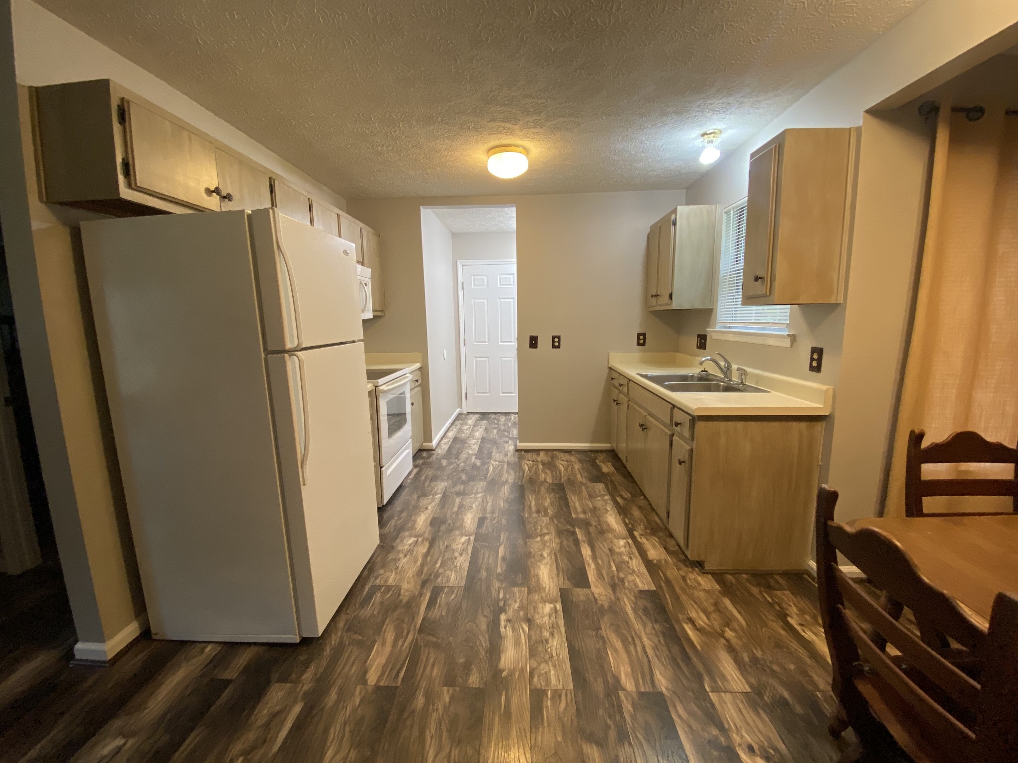 3925 Beasleys Bend Road Lebanon, TN 37087 - Photo 3 of 4 a kitchen with sink a refrigerator freezer a washer and dryer
