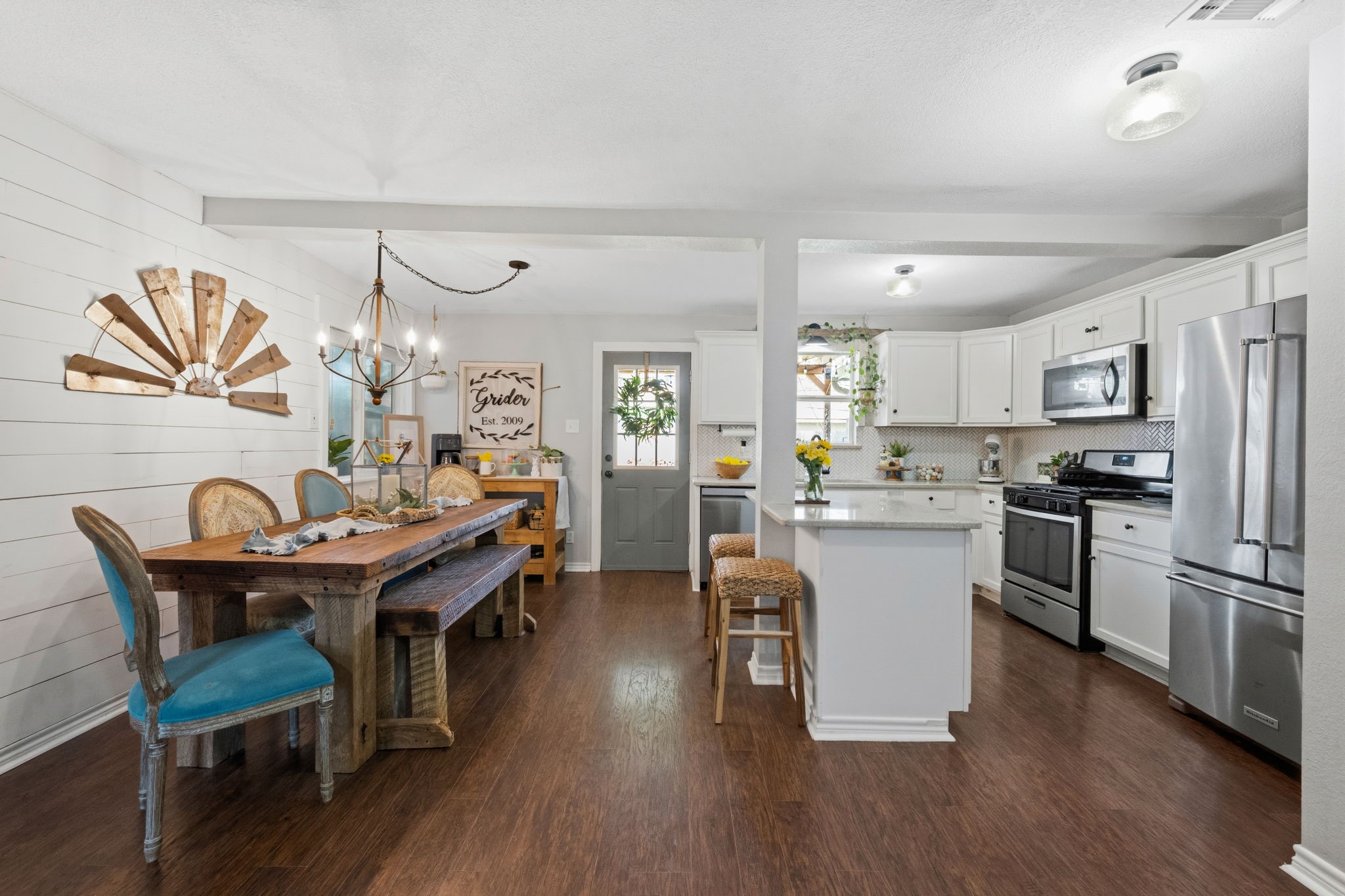 431 Corydon Drive Houston, TX 77336 - Photo 8 of 26 Open-concept dining and kitchen area with seamless flow, anchored by warm, laminate wood flooring and abundant natural light. This layout is ideal for both everyday living and entertaining.