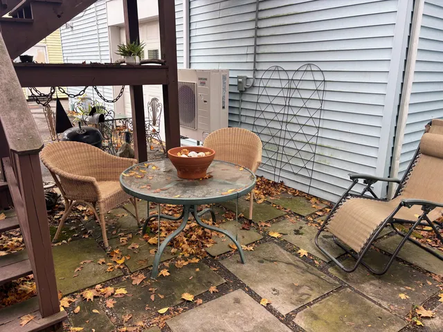 a backyard of a house with table and chairs