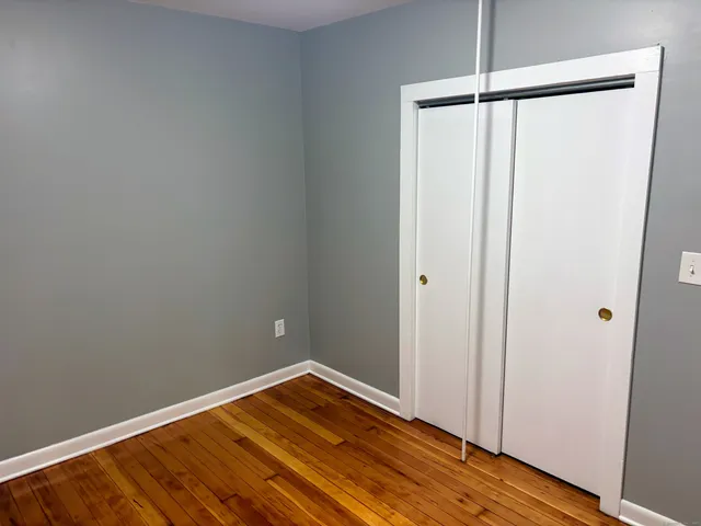 a view of a room with wooden floor