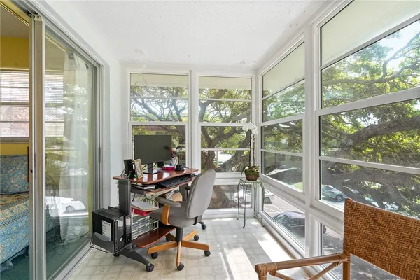 a view of a room with workspace and a large window