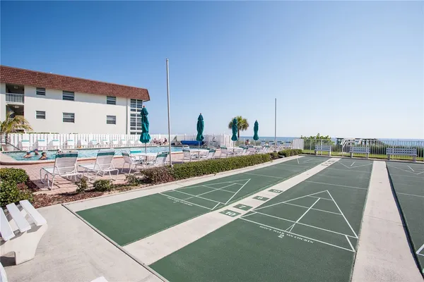 a view of swimming pool with outdoor seating and plants