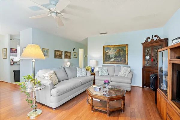 a living room with furniture and a wooden floor