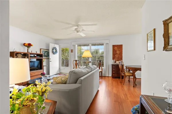 a living room with furniture and wooden floor