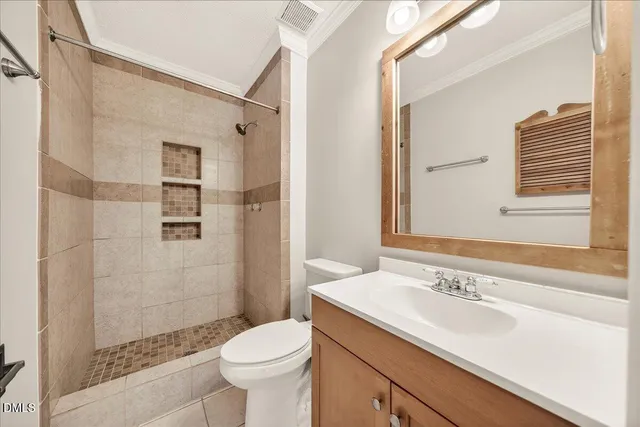 an empty room with closet and a chandelier fan