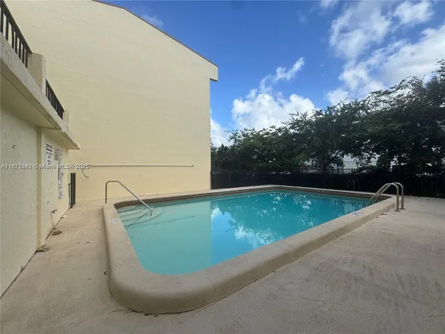 a view of a swimming pool with a yard